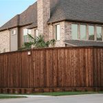 house with red oak fence