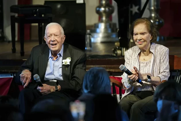 Former President Jimmy Carter and his wife, Rosalynn Carter, sit together during a reception