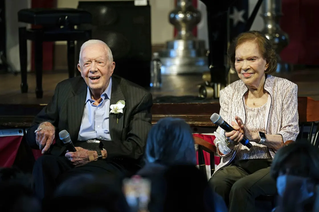 Former President Jimmy Carter and his wife, Rosalynn Carter, sit together during a reception