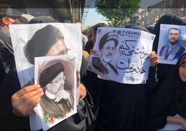 In Tehran's city centre, mourners clutched portraits of Raisi as they gathered in and around the University of Tehran. [Abedin taherkenareh/EPA]