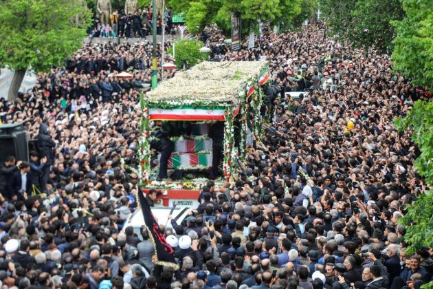 People participate in a funeral procession alongside a lorry carrying the coffins of president Ebrahim Raisi and his seven aides in Tabriz, East Azerbaijan province. Photo: AFP