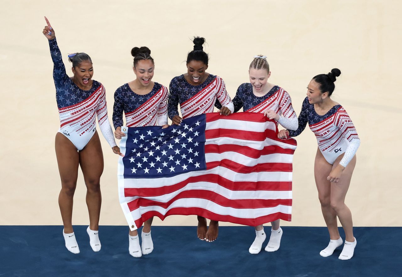 Left to right: Jordan Chiles, Hezly Rivera, Simone Biles, Jade Carey and Suni Lee celebrate during winning gold on Tuesday. Ezra Shaw/Getty Images