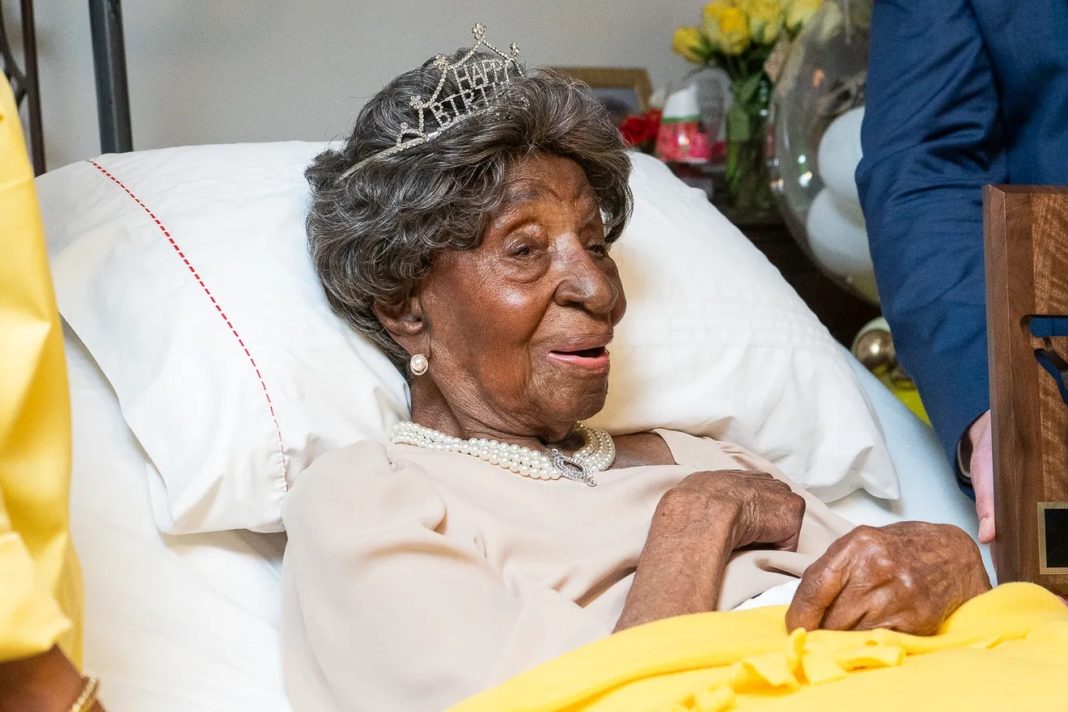 Elizabeth Francis, center, with family members and friends on her 114th birthday in Houston on July 25, 2023. Her daughter, Dorothy Williams, 94, is holding her hand, and granddaughter Ethel Harrison is at left. | Emmanuel Rodriguez