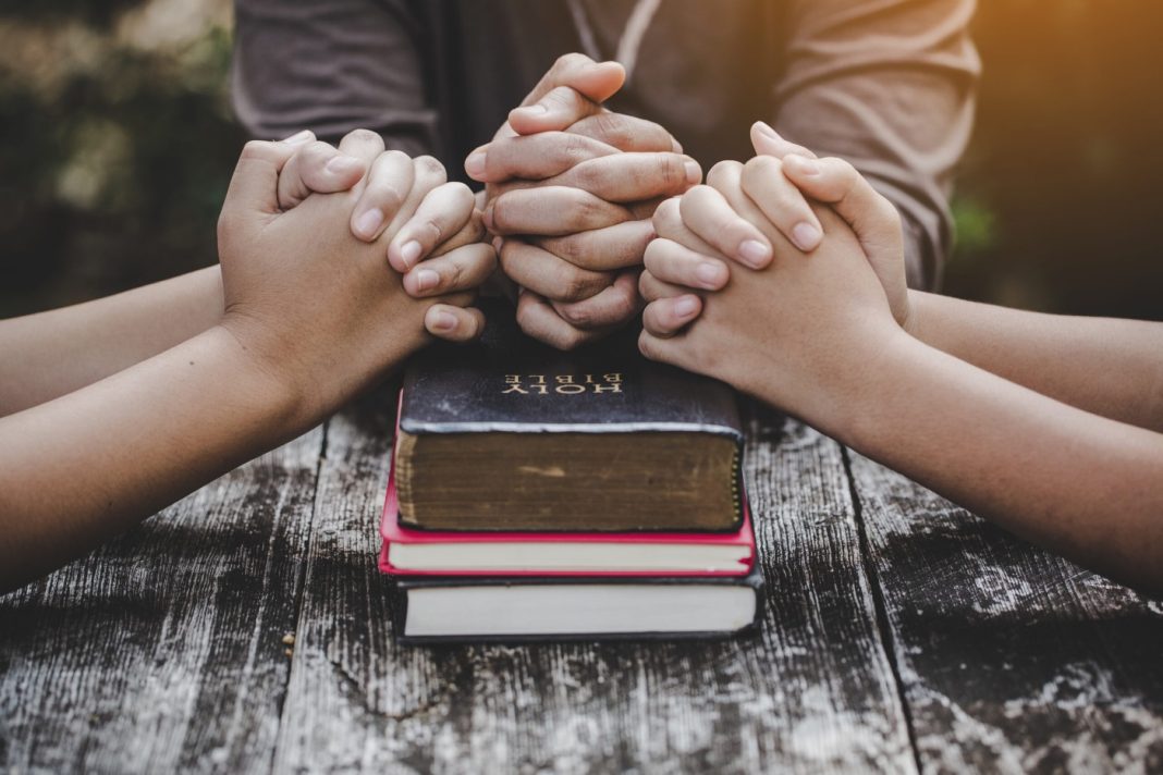 relationship with God young man praying, prayer, group prayer, prayer circle