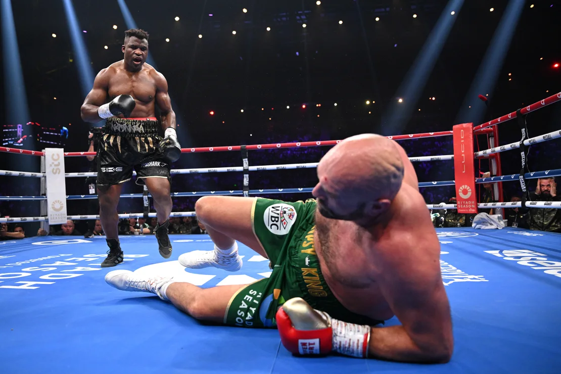 Francis Ngannou knocks down Tyson Fury during their heavyweight fight at Boulevard Hall on October 28, 2023, in Riyadh, Saudi Arabia. | Justin Setterfield/Getty Images