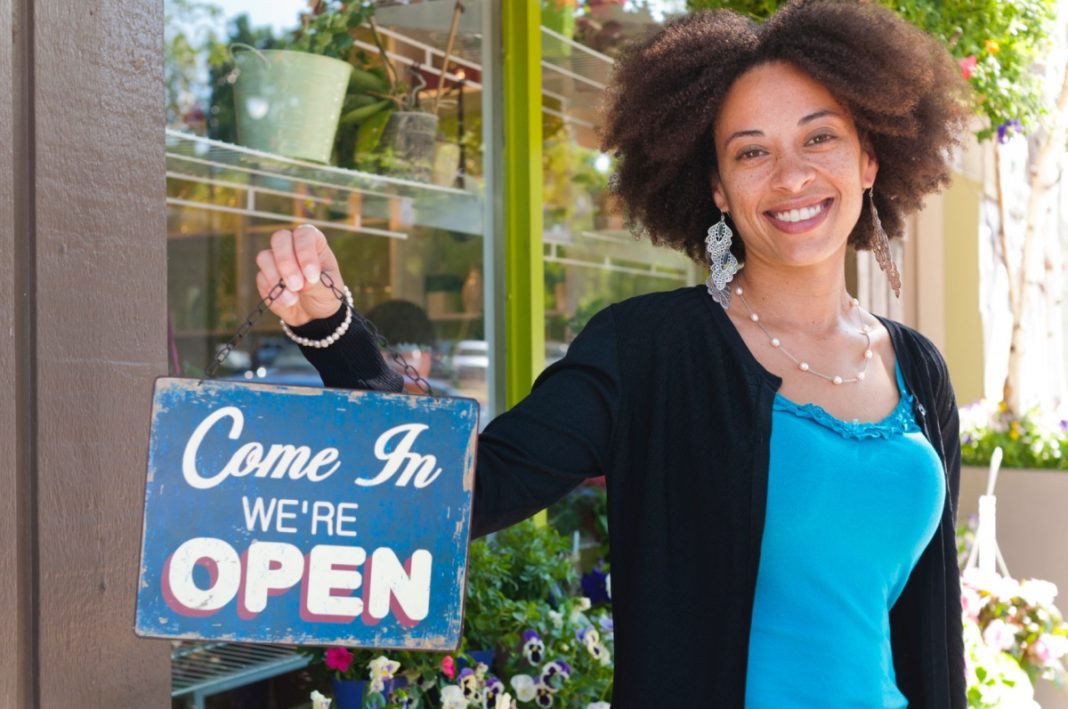 starting a business, business, A black male waiter is standing and holding the tablet and friendly smiling for the wait to welcome customers in the restaurant.