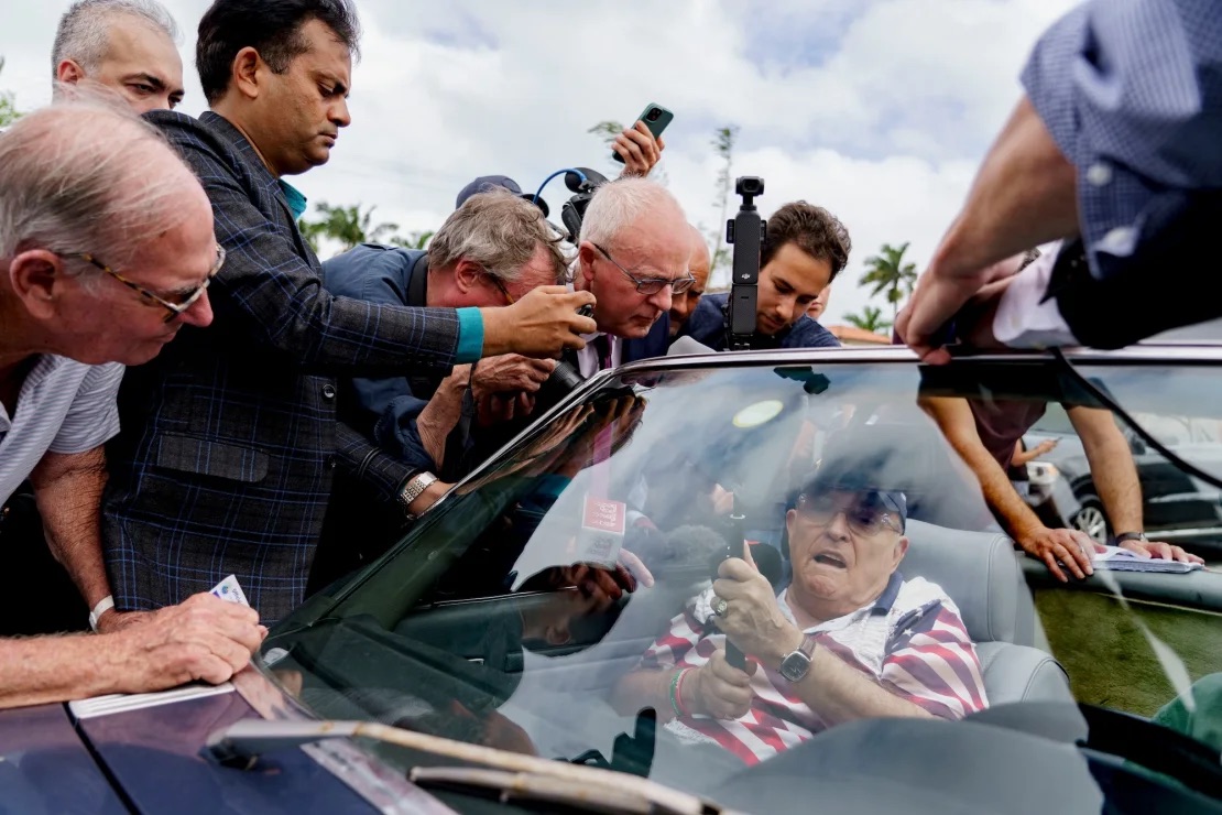 Rudy Giuliani, former lawyer to former US President Donald Trump, center, speaks to members of the media outside a polling location for the 2024 Presidential election at the Mandel Community Center in Palm Beach, Florida, US, on Tuesday, Nov. 5, 2024. | Josh Ritchie/Bloomberg/Getty Images