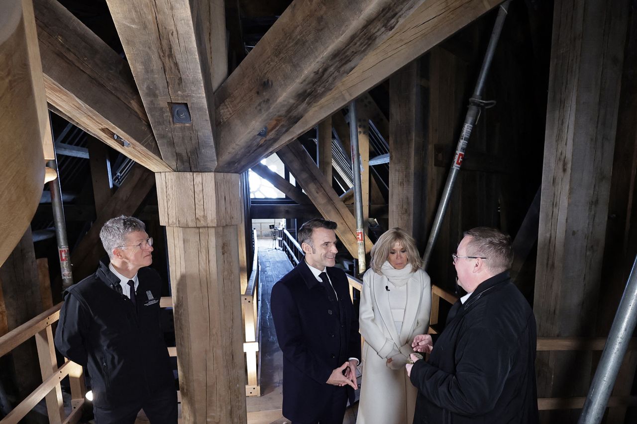 French President Emmanuel Macron and his wife Brigitte Macron visit the spire of Notre-Dame cathedral. | Christophe Petit Tesson/AFP/Getty Images