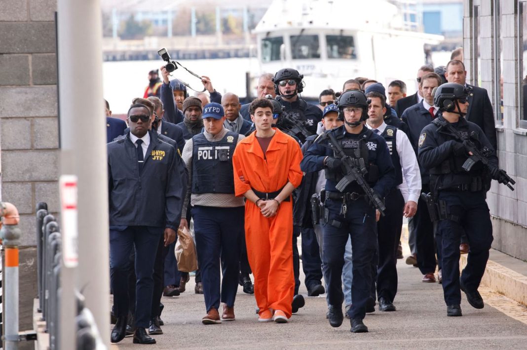 Luigi Mangione is escorted from the Wall Street heliport in Manhattan, New York, on December 19, 2024. | Eduardo Munoz/Reuters