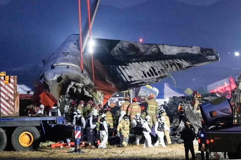 Rescue team carry the body of a passenger at the site of a plane fire at Muan International Airport in Muan, South Korea. | Ahn Young-joon/AP Photo