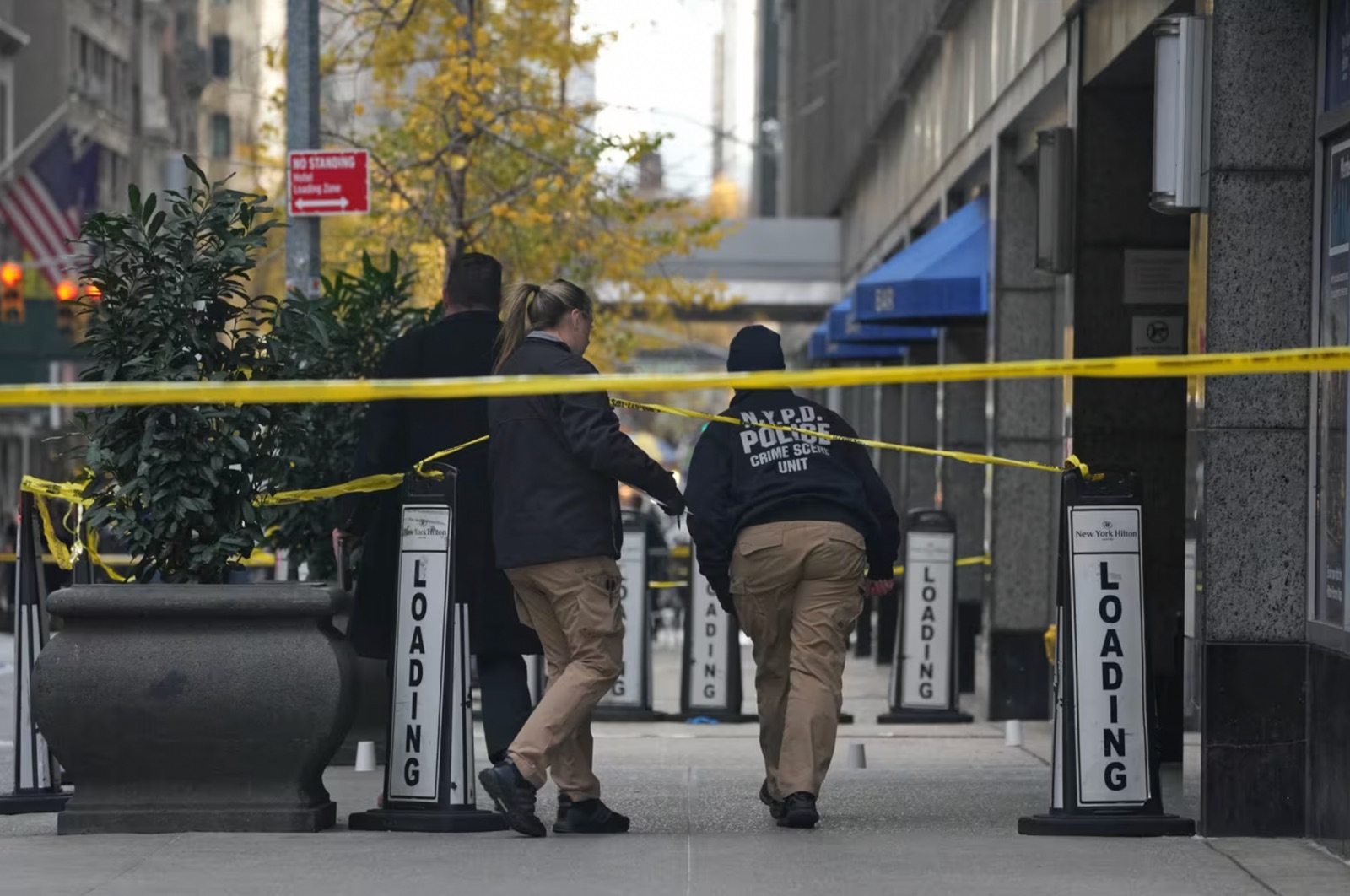 Police cover evidence with paper cups at the scene where Thompson was shot.Bryan R. Smith / AFP - Getty Images