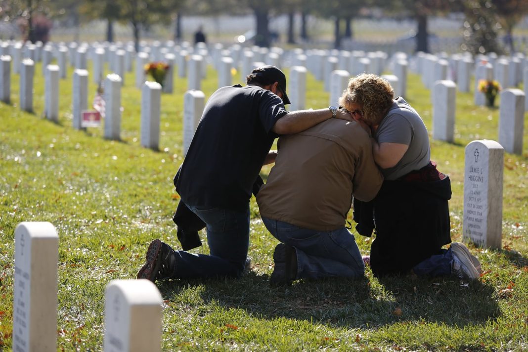 grieving family at cemetary, grave site