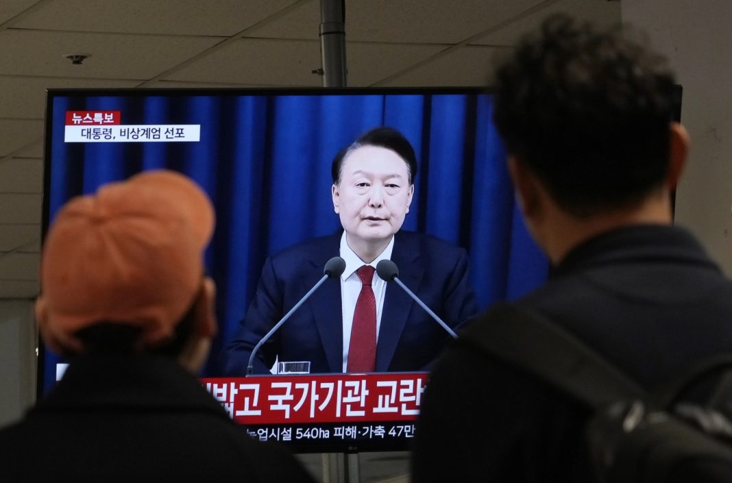 People watch a TV screen showing South Korean President Yoon Suk Yeol’s televised briefing at a bus terminal in Seoul, South Korea, Tuesday, December 3, 2024. | AP Photo/Ahn Young-joon 