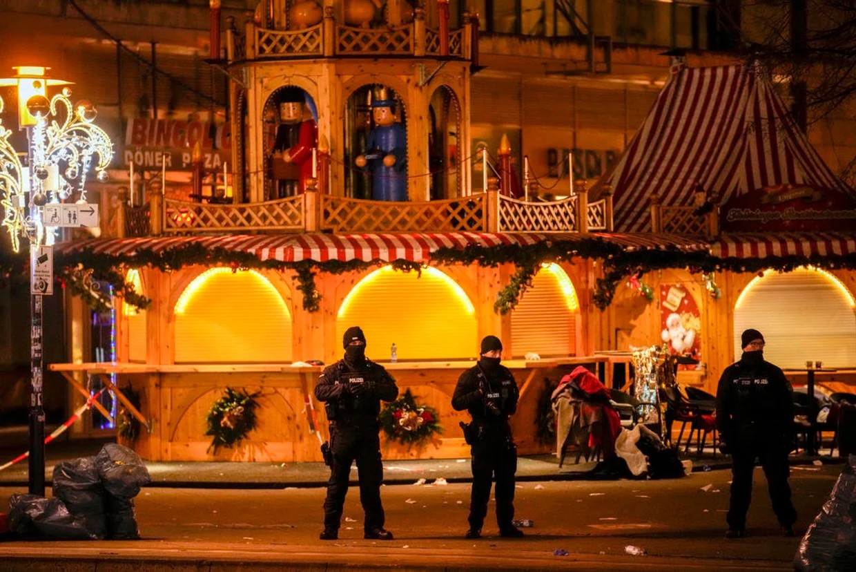 Security guards stand in front of a cordoned-off Christmas Market after a car crashed into a crowd of people, in Magdeburg, Germany, Saturday early morning, Dec. 21, 2024. | Ebrahim Noroozi / AP