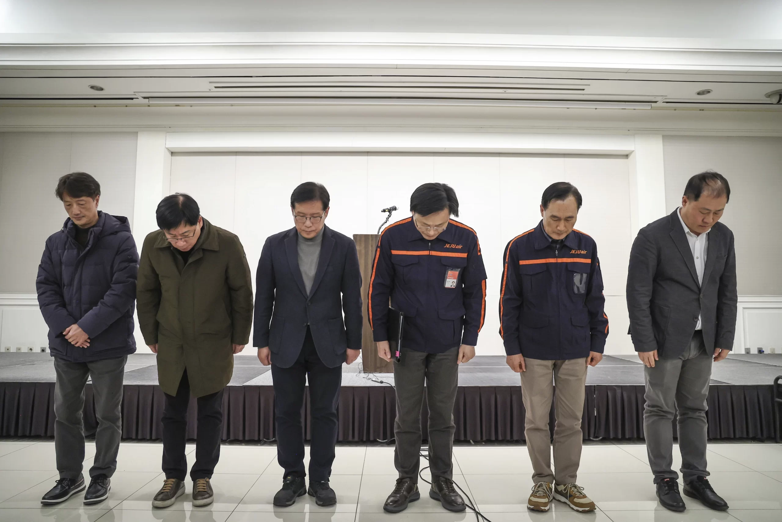 Jeju Air CEO Kim E-bae, fourth from left, and other executive members bow in apology ahead of a briefing in Seoul, South Korea, Sunday, December 29, 2024, after a Jeju Air passenger plane crashed at the airport. | Im Hun-jung//Yonhap via AP