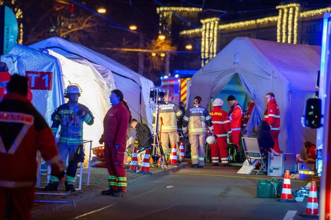 Police vans and ambulances at the scene of the annual Christmas market in Magdeburg, Germany, after a car drove into the crowd on