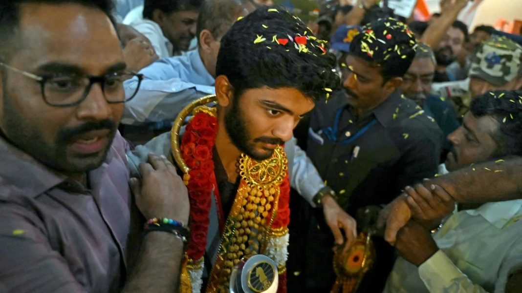 is welcomed home upon his arrival at the Chennai International Airport on December 16 after his win at the FIDE World Chess Championship in Singapore. | R. Satish Babu/AFP/Getty Images