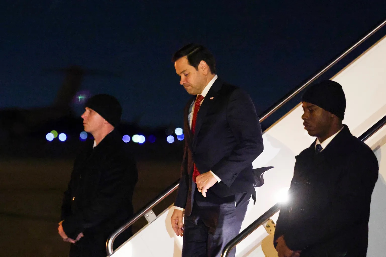 U.S. Secretary of State Marco Rubio disembarks a plane as he arrives back at Joint Base Andrews, M.d., after the plane experienced a mechanical issue while flying him to the Munich Security Conference and returned Thursday, Feb. 13, 2025. | Evelyn Hockstein/Pool Photo via AP