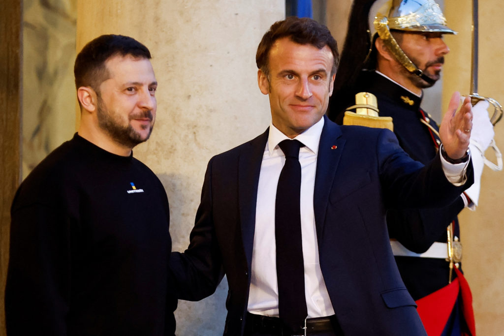 Left: French President Emmanuel Macron welcomes Ukraine's President Volodymyr Zelenskyy at the Elysee Palace in Paris, France, May 14, 2023. Photo by Christian Hartmann/Pool via REUTERS