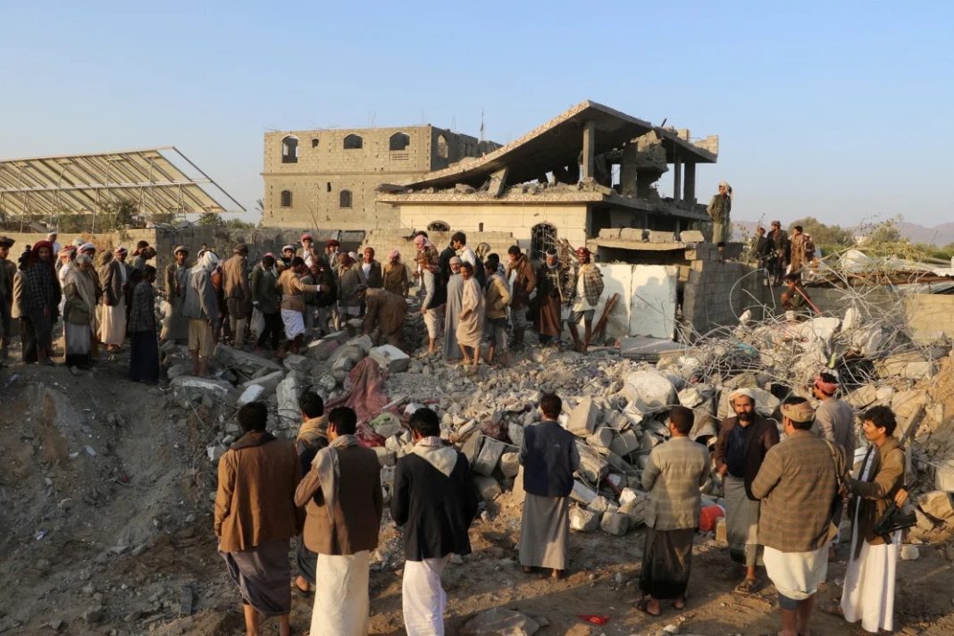  People gather at the site of a house hit by a strike in Saada, Yemen, March 16, 2025, on Sunday. | Naif Rahma/Reuters